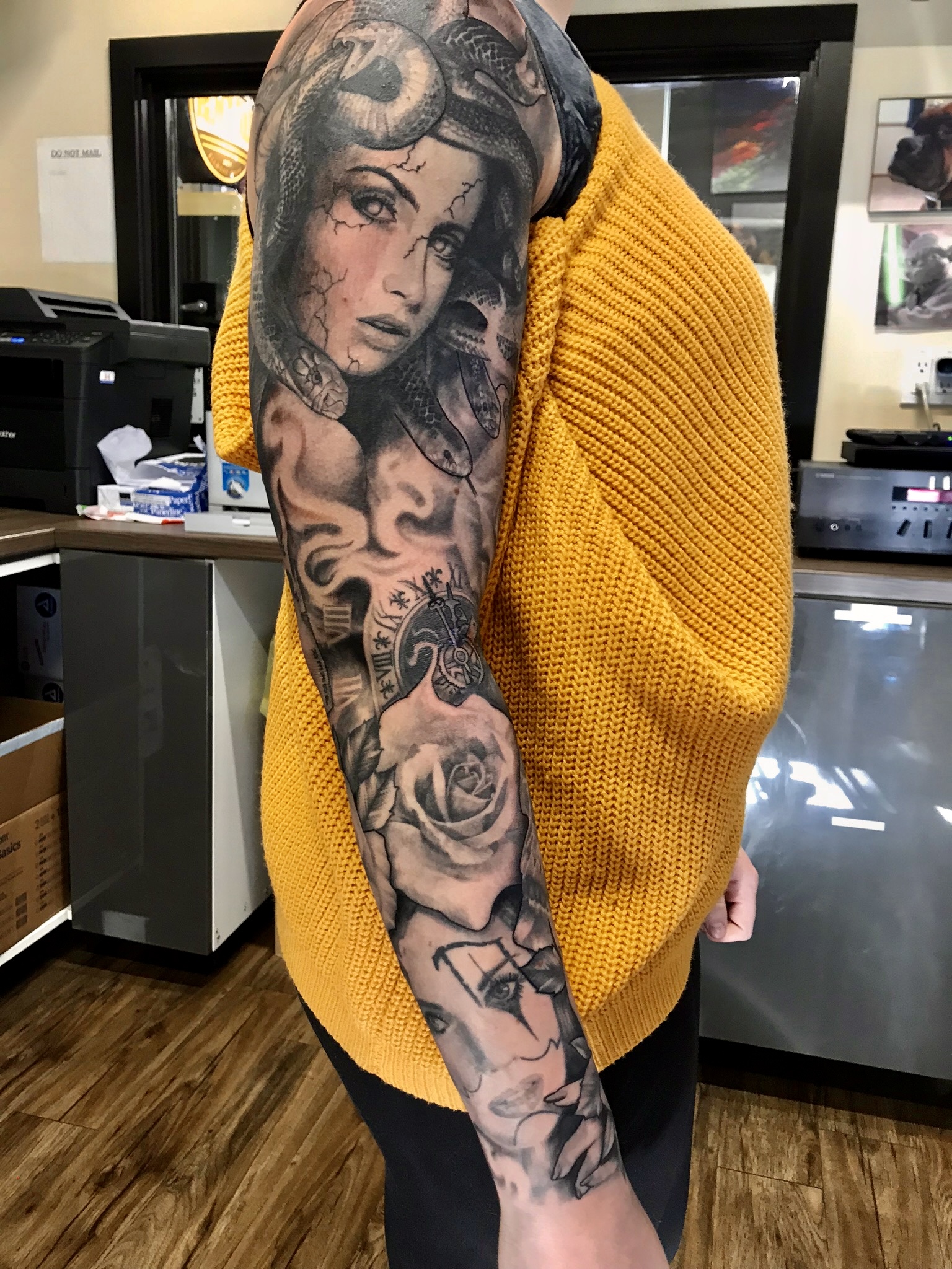 Woman snakes and roses sleeve tattoo