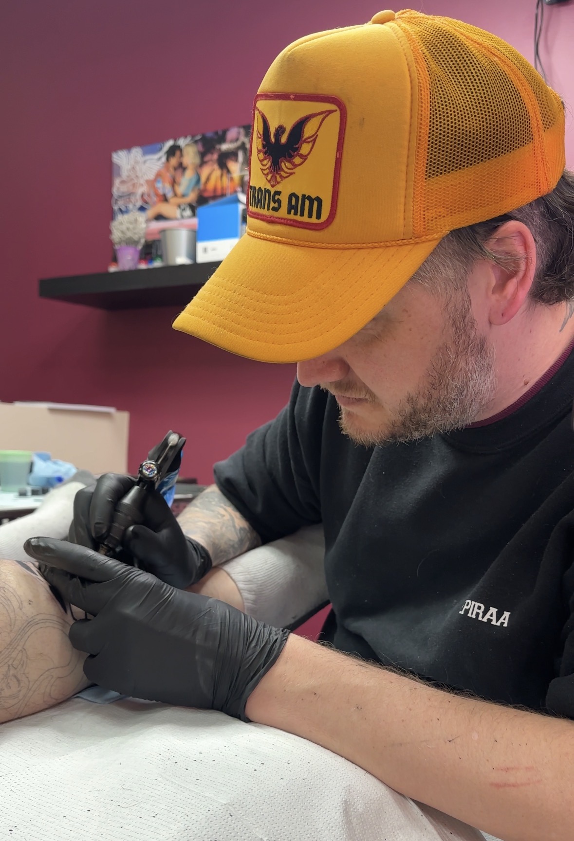 Coatsie tattooing a large black and grey tattoo piece
