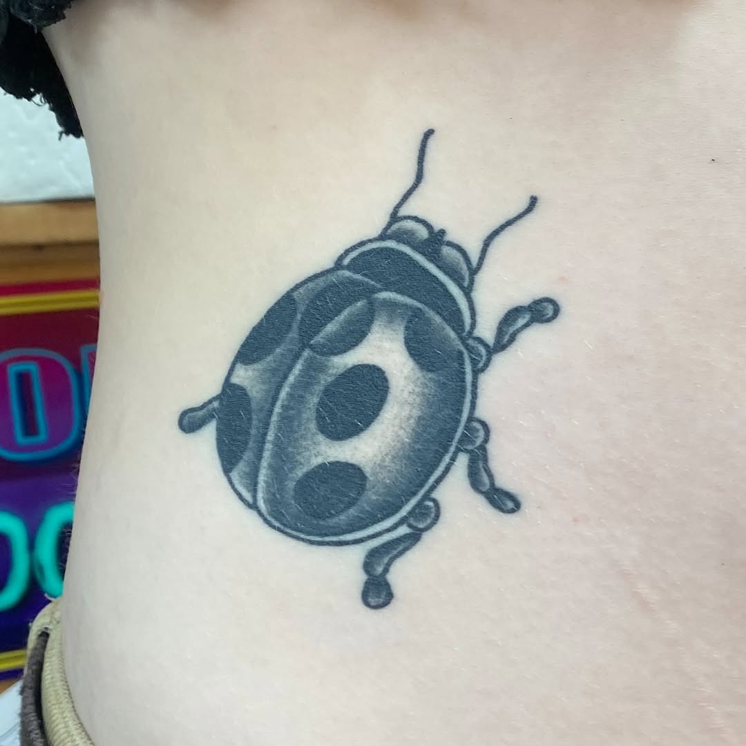 Black and grey ladybug tattoo by Marshall