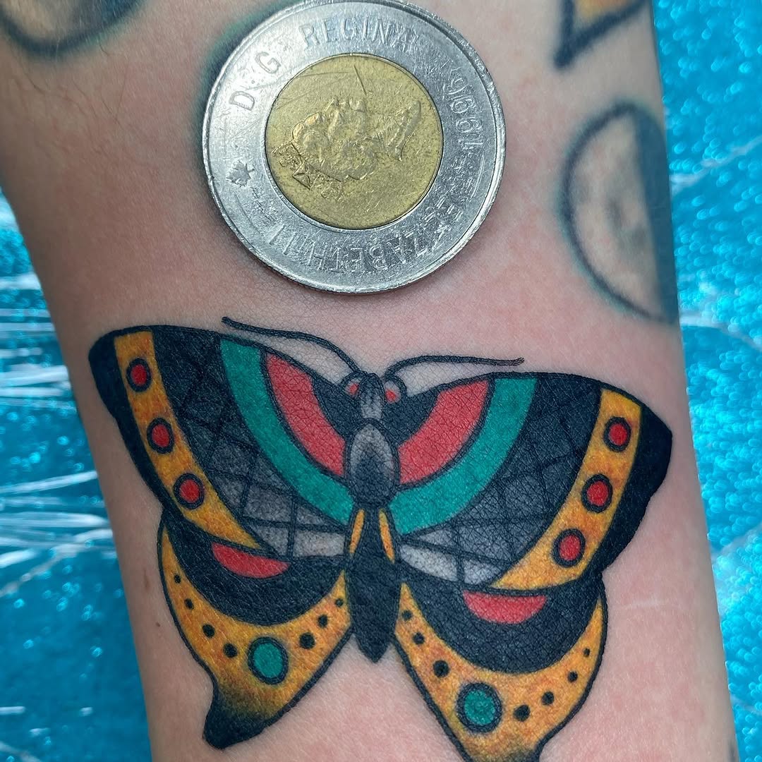 Small colour moth tattoo by Marshall