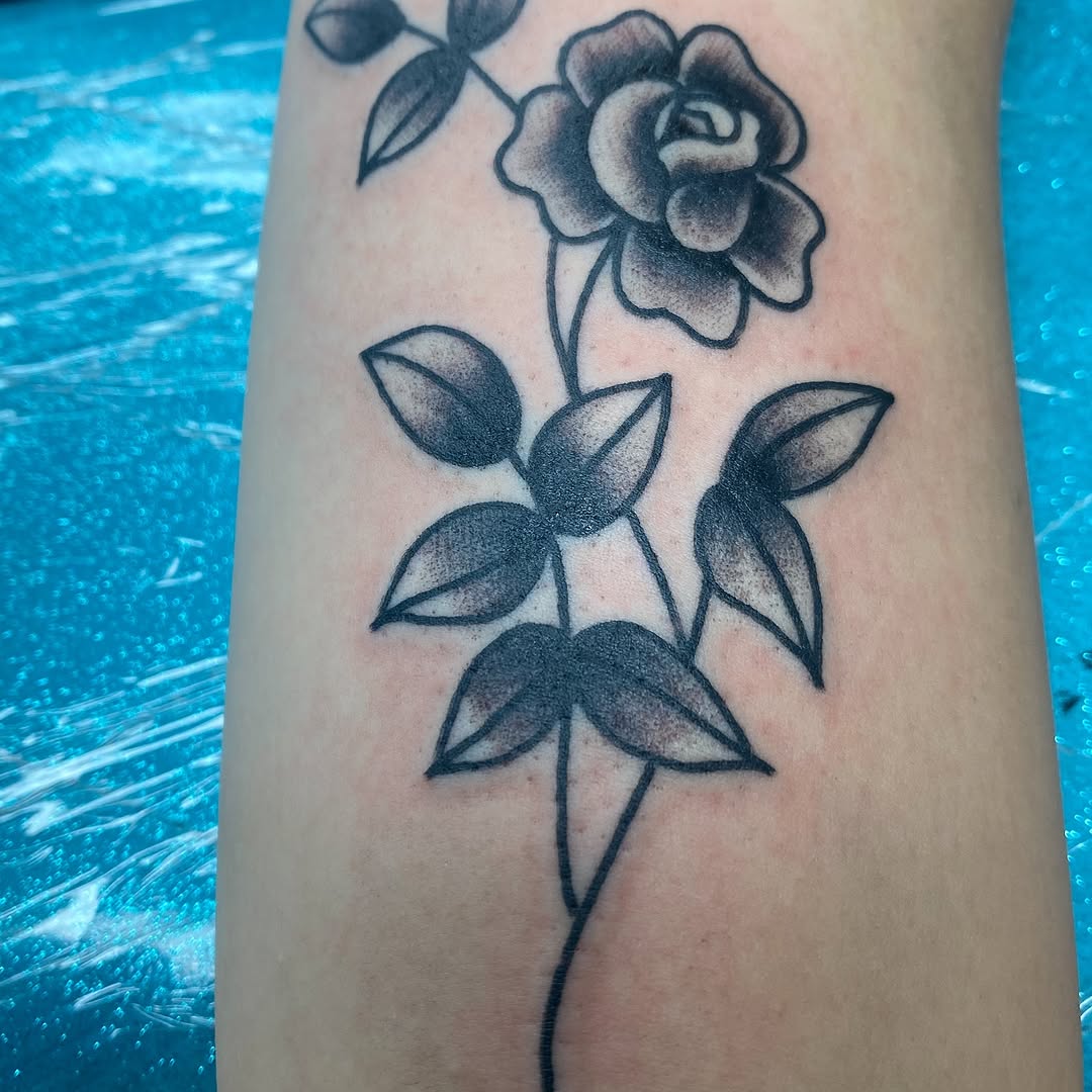 Black and grey rose tattoo by Marshall