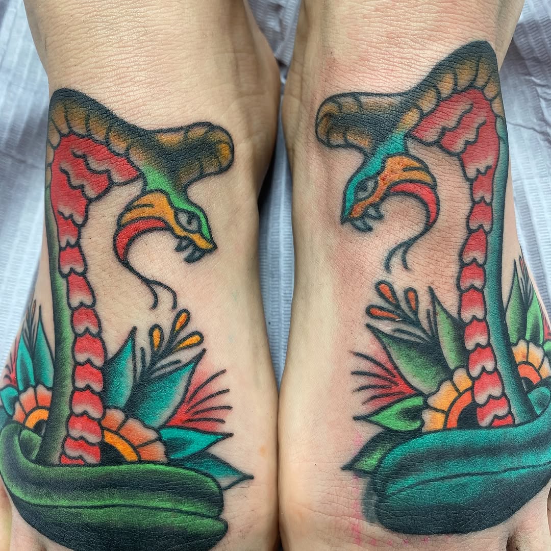 Matching colour cobra tattoos by Marshall