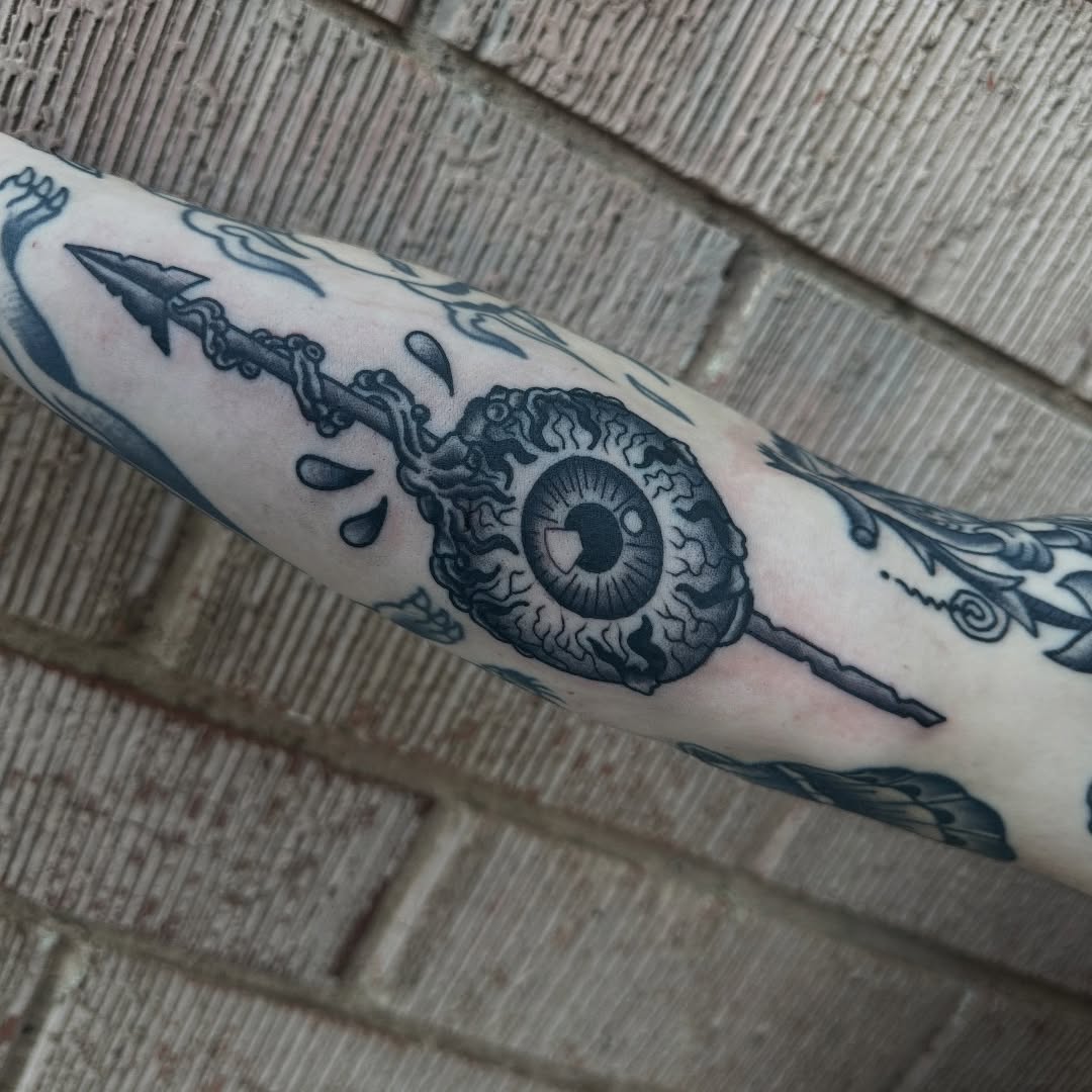 Black and grey eye flail tattoo by Marshall