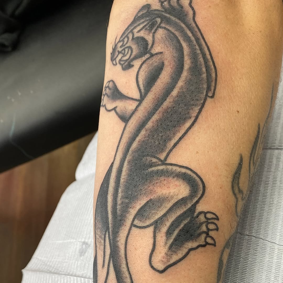 Black and grey climbing panther tattoo by Marshall