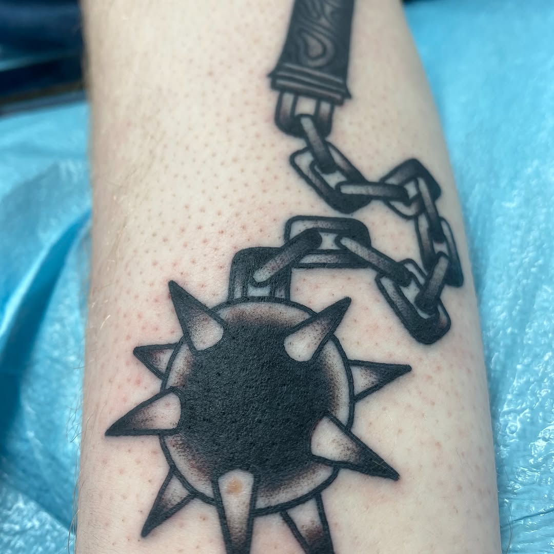 Black and grey medieval flail tattoo by Marshall