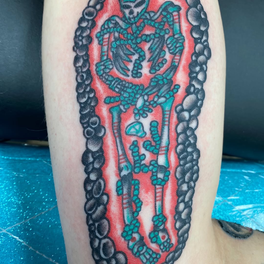 Black and red coffin tattoo by Marshall
