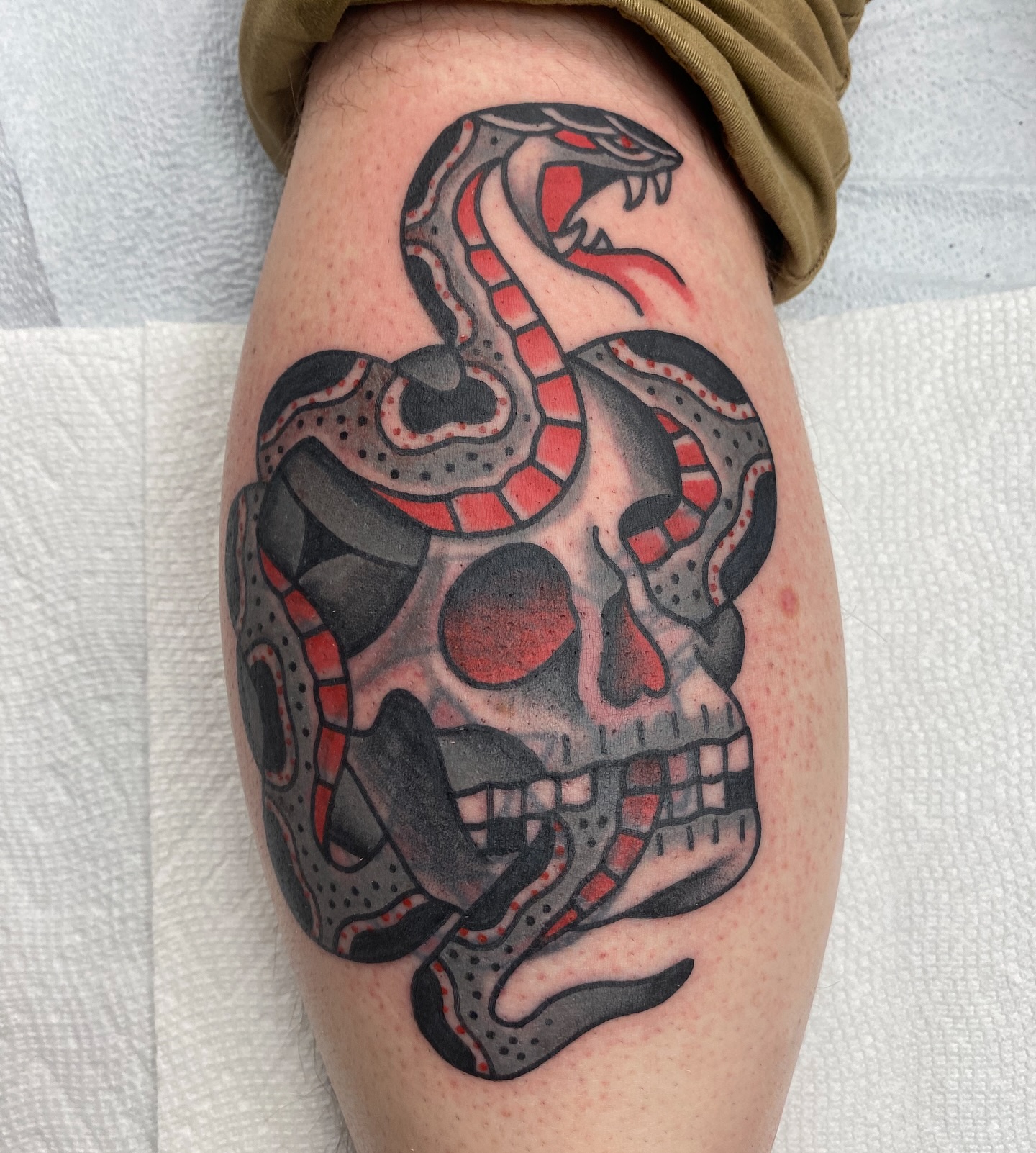 Snake and skull blast-over tattoo by Marshall