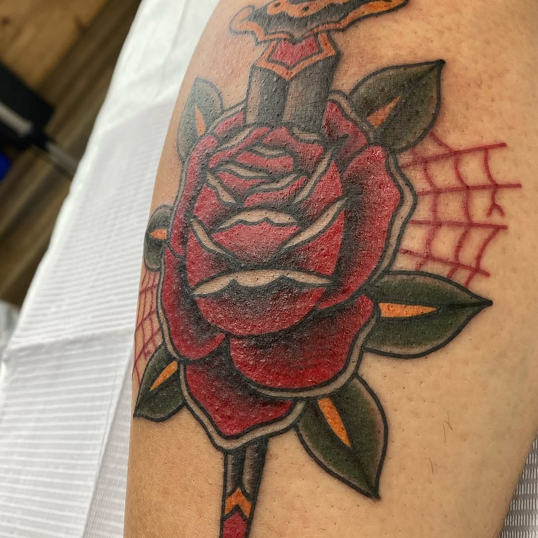 Traditional rose and dagger tattoo by Marshall