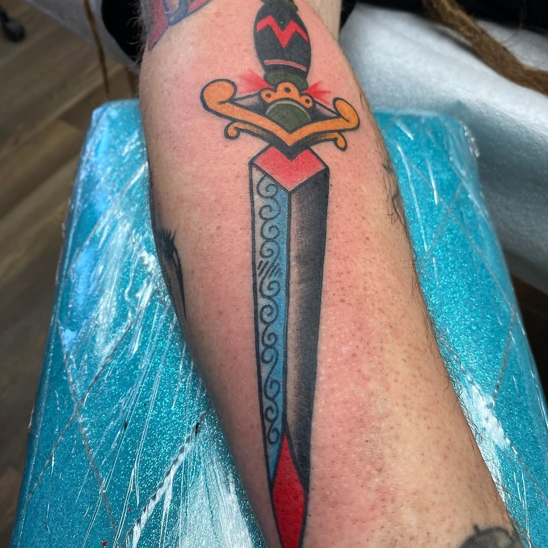 Black and red dagger tattoo by Marshall