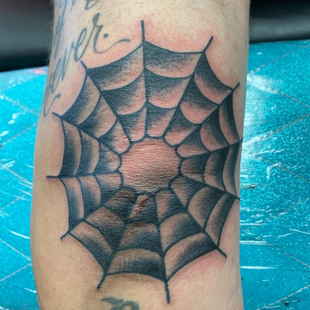Black spiderweb tattoo by Marshall